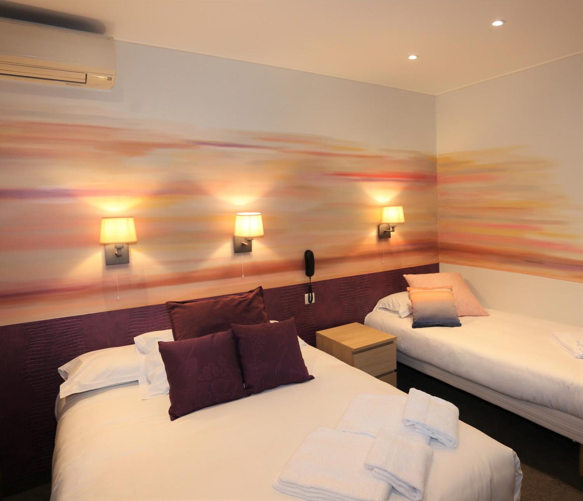 Triple Room window overlooking a painted wall