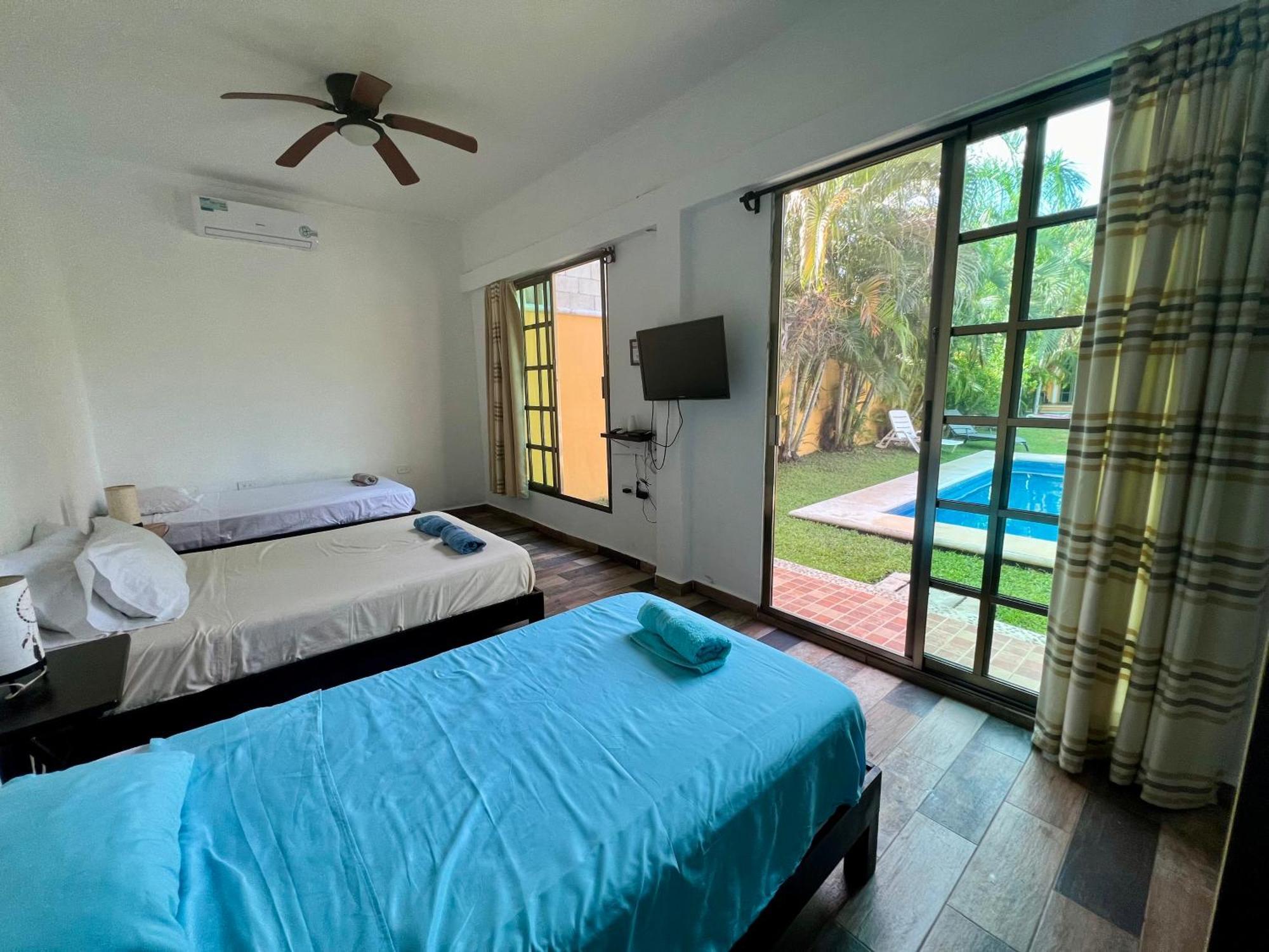 Quadruple Room Balcony view to the garden pool