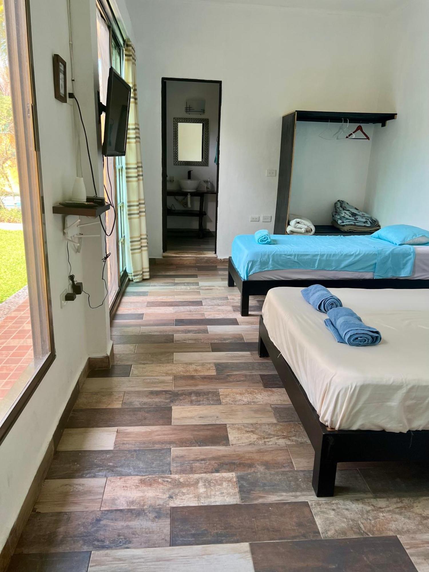 Quadruple Room Balcony view to the garden pool